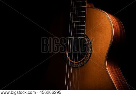 Classical Guitar Up Close On A Black Background With Negative Space For Copy