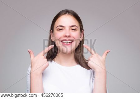 Beautiful Woman Pointing To Teeth. Beautiful Smile With White Teeth. Closeup Smiling Woman Mouth. De