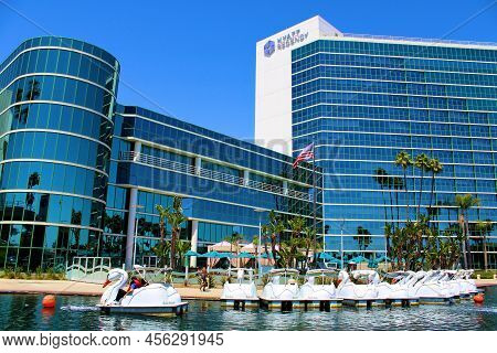 June 12, 2022 In Long Beach, Ca:  People Riding On Swan Style Paddleboats And Docked Paddleboats Bey