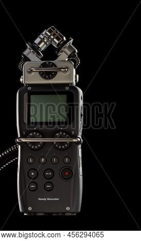 Field microphone recorder isolated on black background