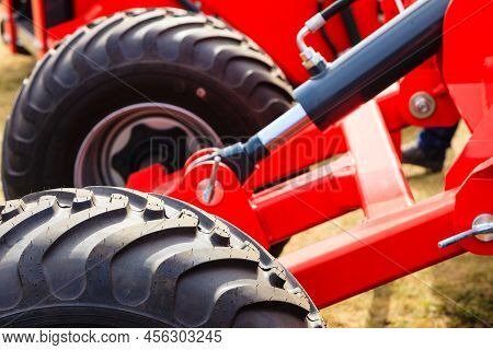 Agriculture Equipment Concept. Detailed Closeup Agricultural Machinery, Big Wheels With Tires. Outdo