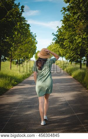 Candid Portrait Of Brunette In Stylish Cocoon With Natural Smile. Breathtaking View Of A Young Lady 
