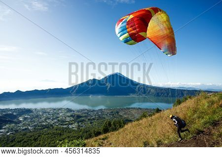 Paraglider Starting From Batur Volcano. Bali, Indonesia