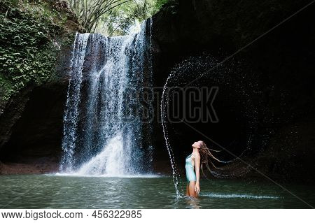 Woman Have Fun In Natural Pool Under Falling Water Of Suwat Waterfall In Tropical Jungle. Nature Day