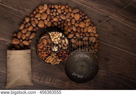 Mixed Nuts In A Tin And Burlap Sack Up Close On A Dark Wood Background