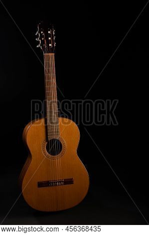 Classical Guitar On A Black Background With Copy Space