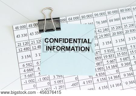 Confidential Information Text On A Card Clip To A Sheet Of Paper On A Table, Business Concept