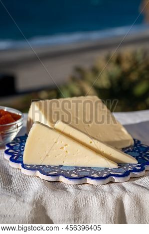 Spanish Hard Goat Cheese Served Outdoor With Membrillo Jam With Blue Sea On Background