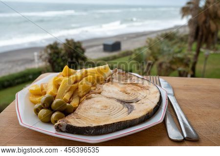 Seafood Dish Served In Beach Cafe With Sea View, Grilled Steak From Swordfish Or Spada Served With F