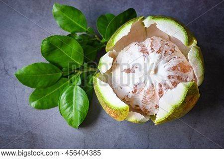Pomelo Fruit On Dark Background, Fresh Green Pomelo Peeled On And Green Leaf Frome Pomelo Tree , Pum