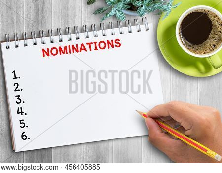 Top View Nominations Concept Hand Drawing In Notebook On Office Desk. Business And Insurance Concept