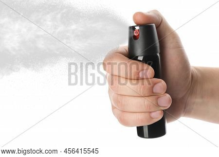 Man Using Pepper Spray On White Background, Closeup