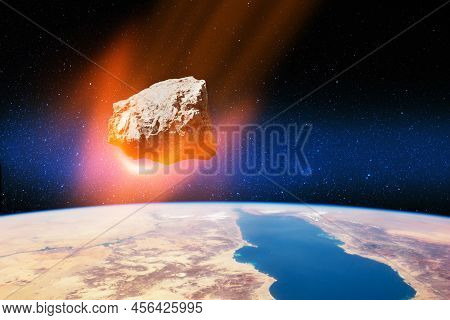 Planet Earth And Big Asteroid In The Space. Potentially Hazardous Asteroids. Asteroid In Outer Space