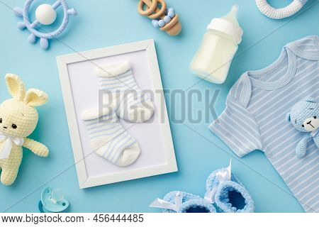 Baby Accessories Concept. Top View Photo Of Photo Frame With Socks Knitted Bunny And Bear Toys Blue 