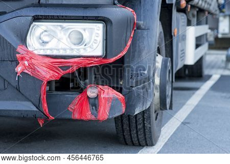 Broken Truck Bumber Fixed-up With A Red Duct-tape. Delivery Truck With A Cracked Front Plastic Bumpe