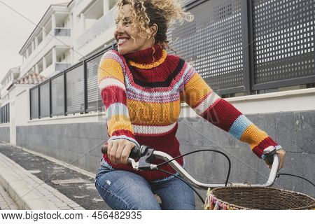Happy Mature Young Woman Riding A Bike And Smiling Enjoying Outdoor Active Healthy Leisure Activity.