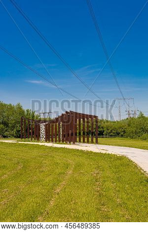 Mast Of Power Lines Under Which There Is A Wooden Crossing. High Quality Photo