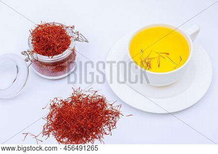 Saffron Drink And A Pile Of Saffron On A White Background.