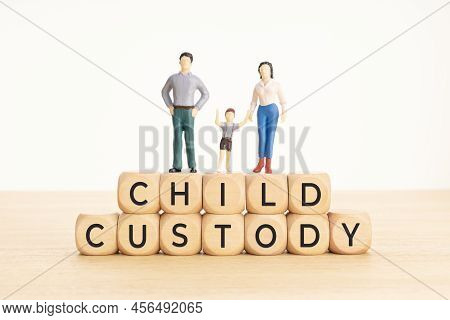 Child Custody Concept. Wooden Blocks With Text And Woman, Man And Child Figurine