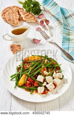 Fasolakia Lathera, Green Beans, Onion And Potatoes Stewed In Tomato, Herbs And Olive Oil On White Pl