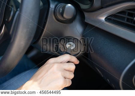 Closeup Inside Vehicle Of Hand Holding Key In Ignition, Start Engine Key,     Woman Driver Starting 