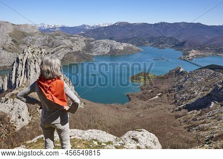 Picturesque Reservoir And Mountain Landscape In Riano. Hikers. Spain