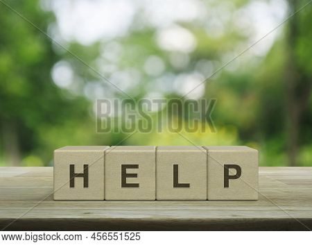 Help Letter On Wood Block Cubes On Wooden Table Over Blur Green Tree In Park, Business Customer Serv