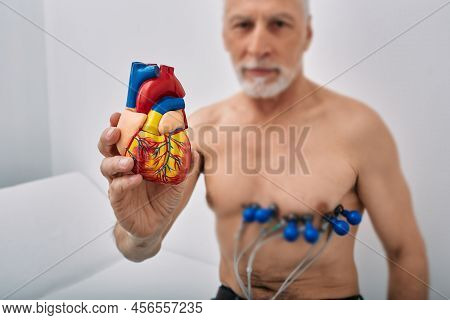 Heart Health Concept, Cardiac Tests, Cardiogram. Senior Man During Heart Test With Sensors, Holds An