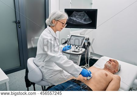 Ultrasound Specialist Doing Ultrasonography Of Abdominal Cavity For Mature Male Patient With Ultraso