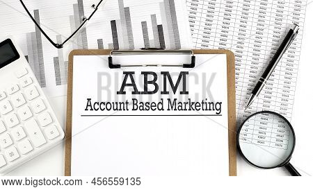 Paper With Abm Account Based Marketing On A Table With Charts
