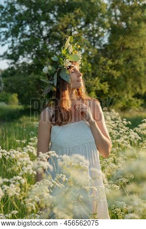 Beautiful Brunette Woman In Flower Wreath. Summer Solstice Day. Midsummer.