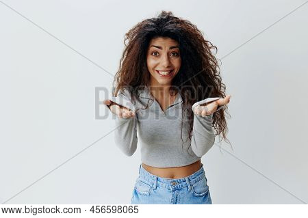 Come To Me. Excited Latin Lady Extending Hands At Camera, Holding Big Invisible Oblect, Arab Woman O