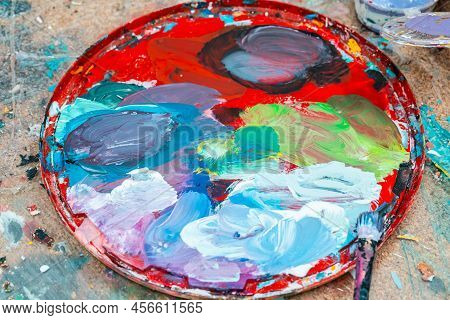 Bright Spots Of Paint In An Art Workshop With A Brush