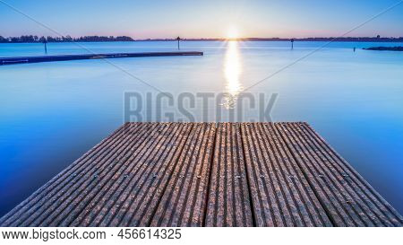 Beach Jetty And Outdoor Swimming Pool At The Wijderwold Lake During An Impressive Sunrise In Zeewold