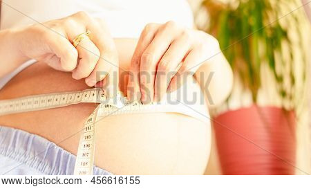 Measure Belly Pregnancy Woman. Happy Young Pregnant Woman With Tape Measuring Belly. Concept Materni