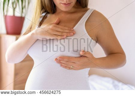 Breast Exam Cancer Pregnancy Woman Check. Happy Young Pregnant Woman Self Exam. Breast Self Exam. He