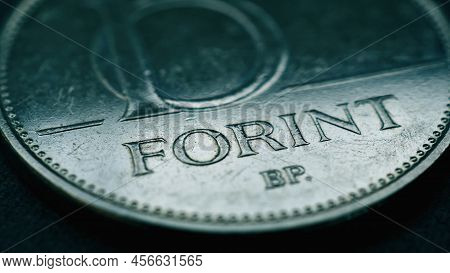 Hungarian Coin Of 10 Forints Lies On Dark Surface Closeup. Money Of Hungary. News About Economy Or F