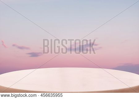 A White Marble Pedestal Or Table Surface On A Lilac Twillight Sky Background. Copy Space. The Concep