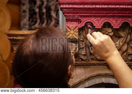 Woman Creatively Restoring Antique Wooden Cupboard With Hand Carved Ornaments. Re-usage Of Old Furni