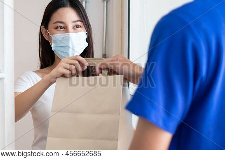 Young Asian Woman, Customer Wearing Face Mask Protect To Pandemic Of Covid And Received Bag,cardboar