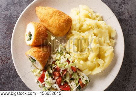 Ukrainian Dinner Chicken Kiev Cutlets Served With Salad And Mashed Potatoes Closeup In The Plate On 