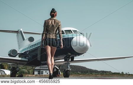 Stewardess In Blue Uniform - Back View. Pretty Female Flight Attendant In Airport. Charming Stewarde