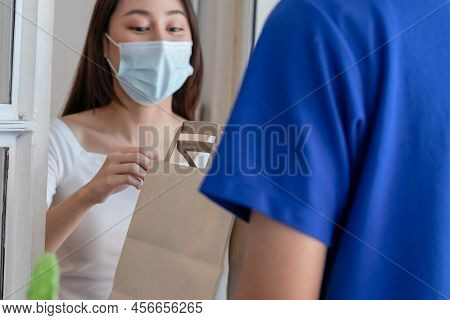 Young Asian Woman, Client Received A Delivery Of Bag, Cardboard Box From Delivery Man Wearing Face M