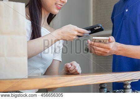 Young Asian Woman,client Using Mobile Scan Eceived A Delivery Of Baggage, Cardboard Box From Deliver