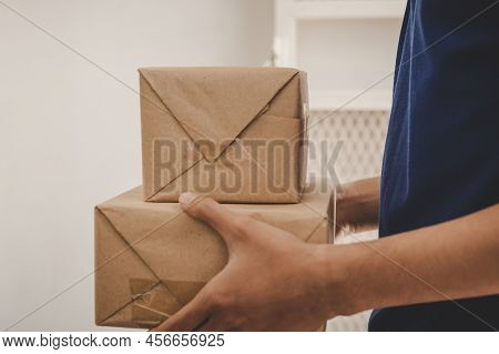 Delivery Man Employee, Postman Hold Cardboard Box,parcel Or Packet For Send To Client,customer In Bl