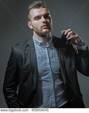 Male Smell. Man Holding Bottle Of Perfumery. Mans Perfume Concept. Elegant Man For Perfume. Masculin