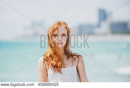 Sunner Portrait Of Redhead Beautiful Girl At Beach. Young Tanned Woman Enjoying Breeze At Seaside. C