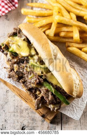 Philly Cheesesteak Sandwich With Beef, Cheese,green Pepers And Caramelized Onion On Wooden Table.tra