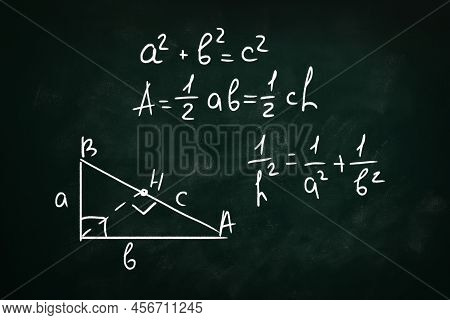 Basic Triangle Area Formulas And Pythagorean Theorem Written On Chalkboard