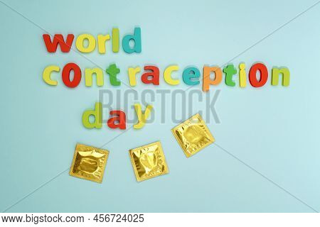 World Contraception Day. Condom On A Blue Background. Flat Lay